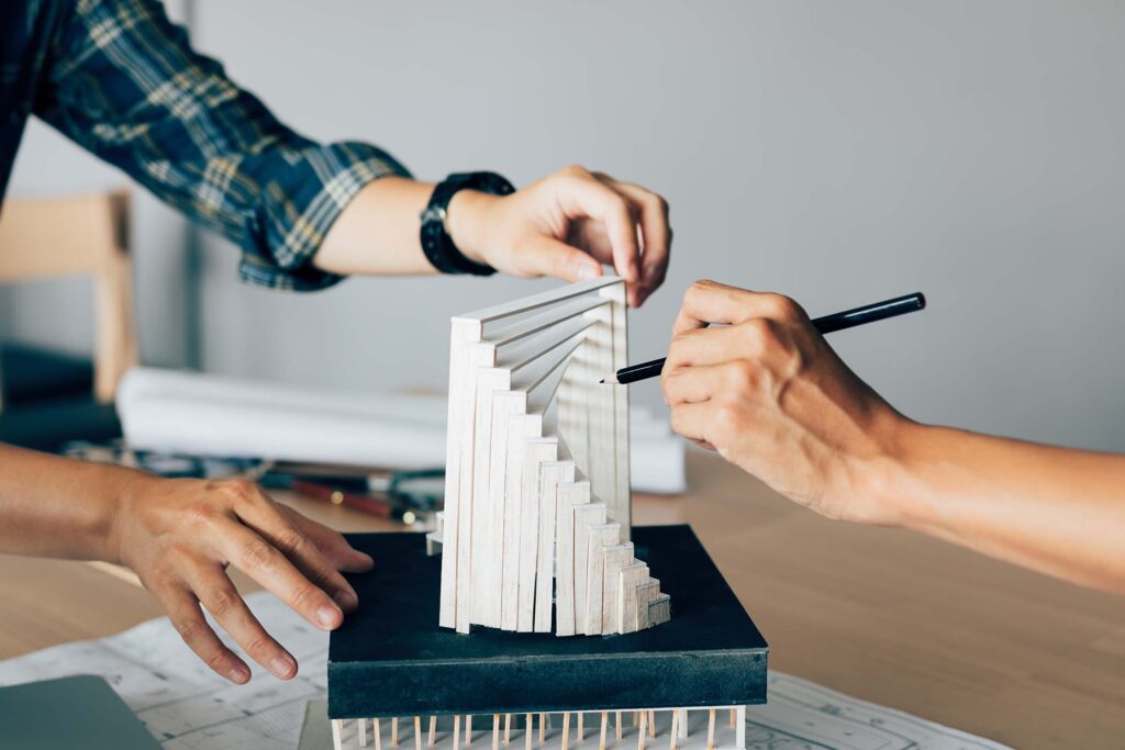 architect-reviewing-architectural-model-in-the-off-8NJ25R9.jpg